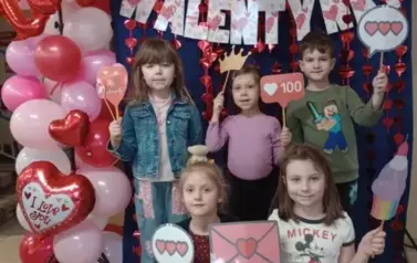 dzieci pozują na ściance walentynkowej
