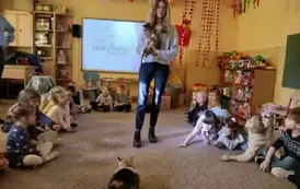 opiekunka trzyma na rękach kota