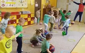 dzieci kładą piłki na krążkach