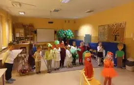 dzieci przebrane za warzywa stoją na sali