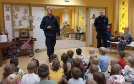 Policjanci prowadzą prelekcję dla dzieci na temat bezpieczeństwa na drodze